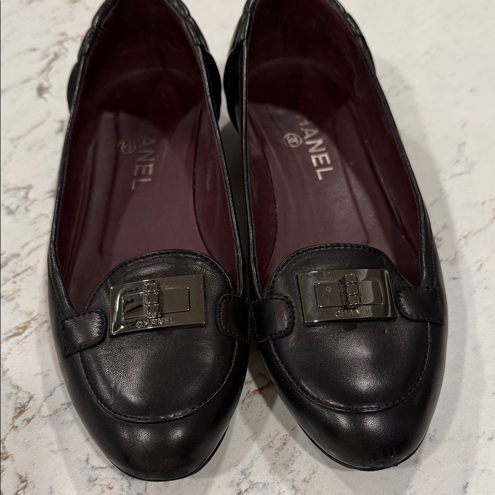 CHANEL Black Leather quilted Flats with Silver turn lock